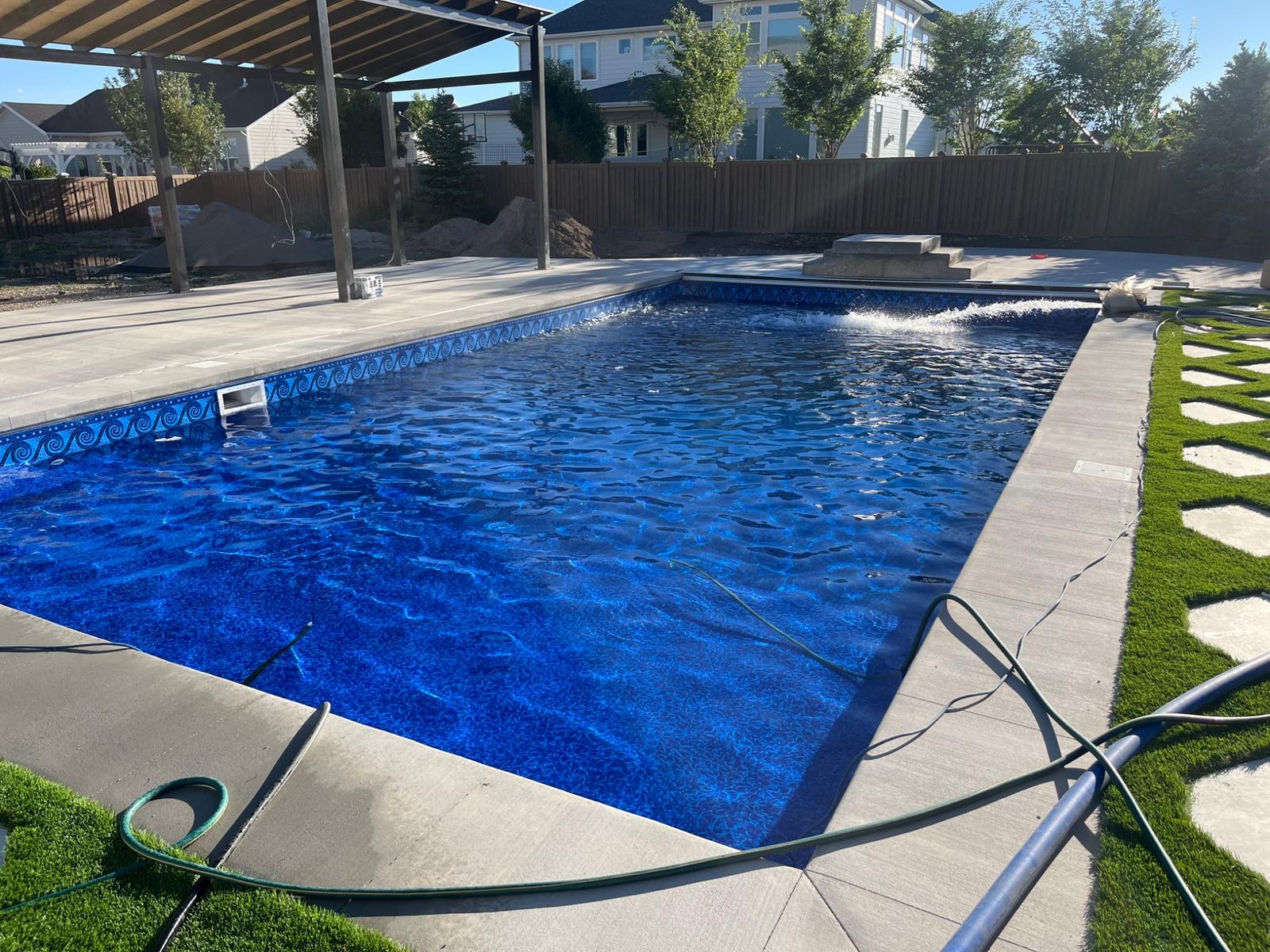 Deep blue custom pool with modern concrete decking